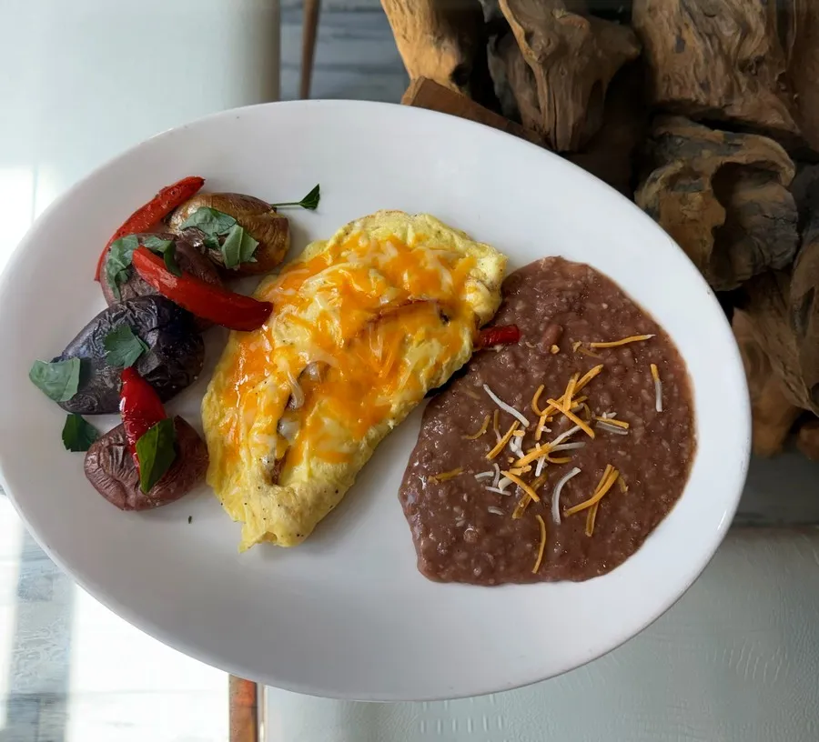Omelet with melted cheese, refried beans and potatoes