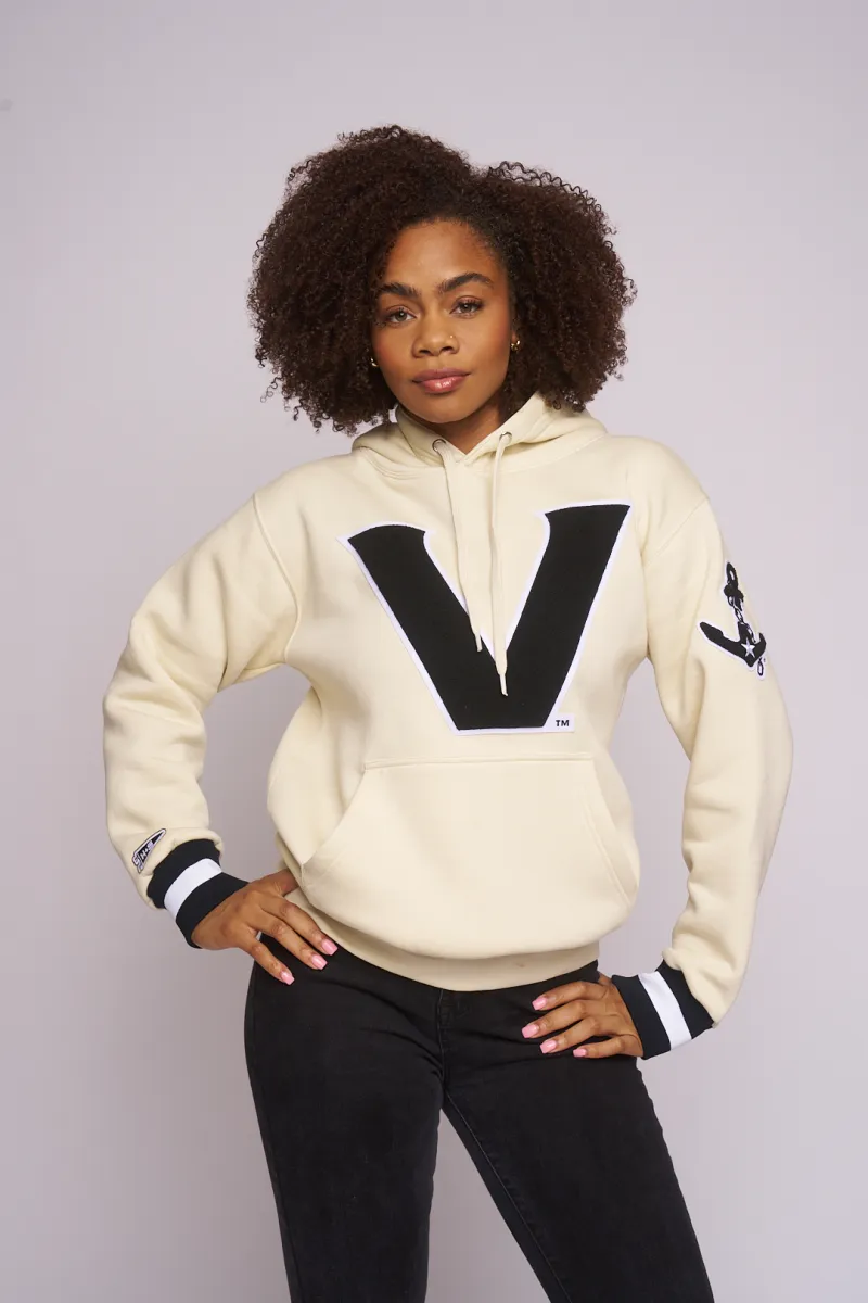 Model in the cream Vanderbilt V hoodie, hands on hips